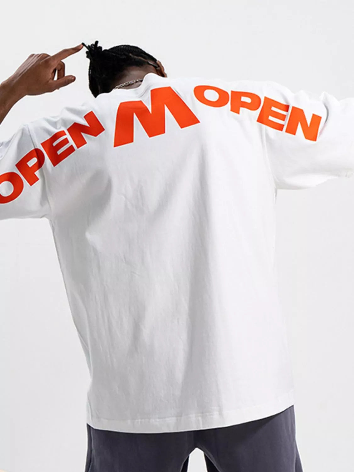 Person wearing a white shirt with 'OPEN' printed on the back against a light gray background