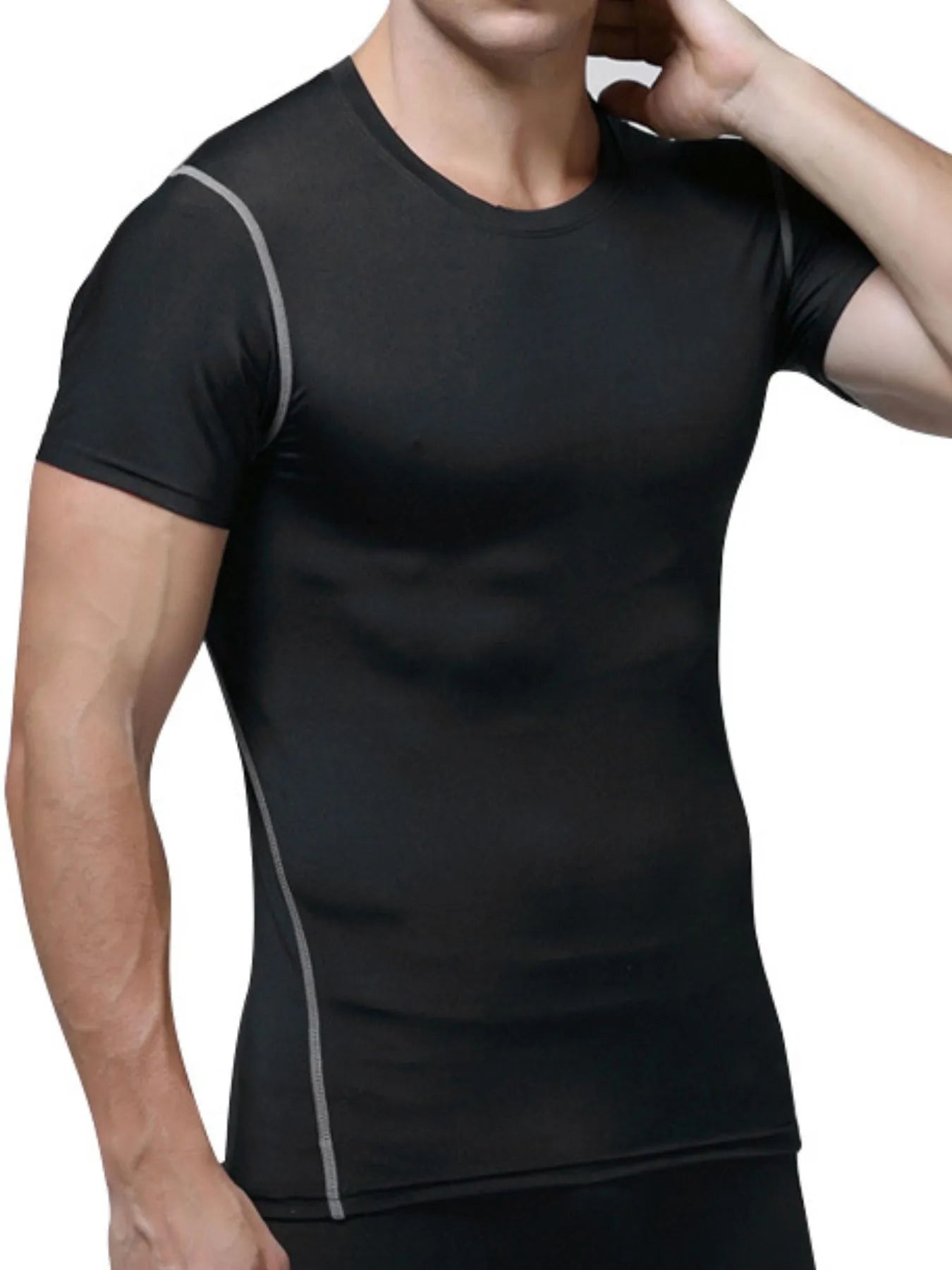 Black athletic shirt with gray seam lines worn by a person on a white background