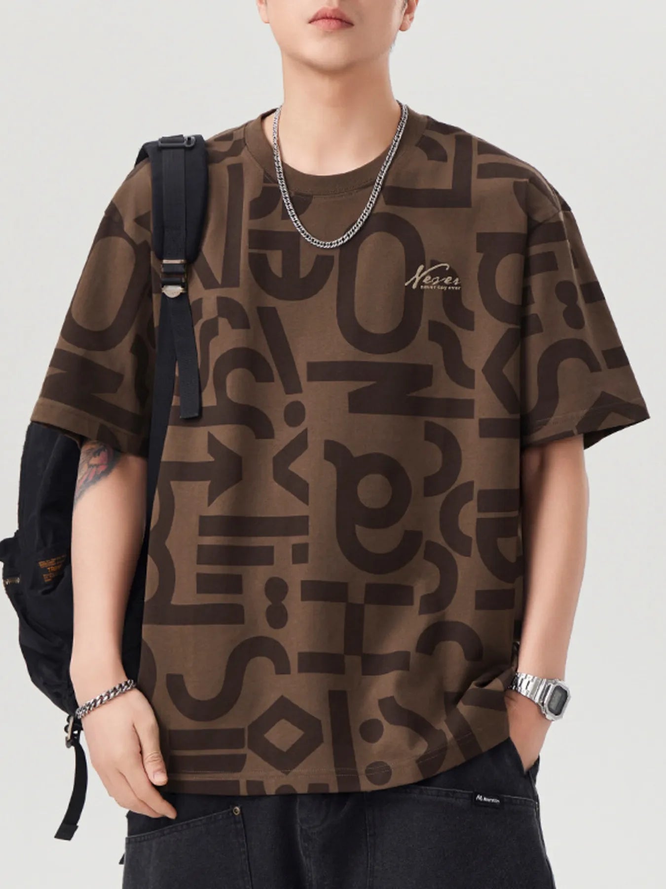 Person wearing a brown patterned t-shirt with a backpack on a white background