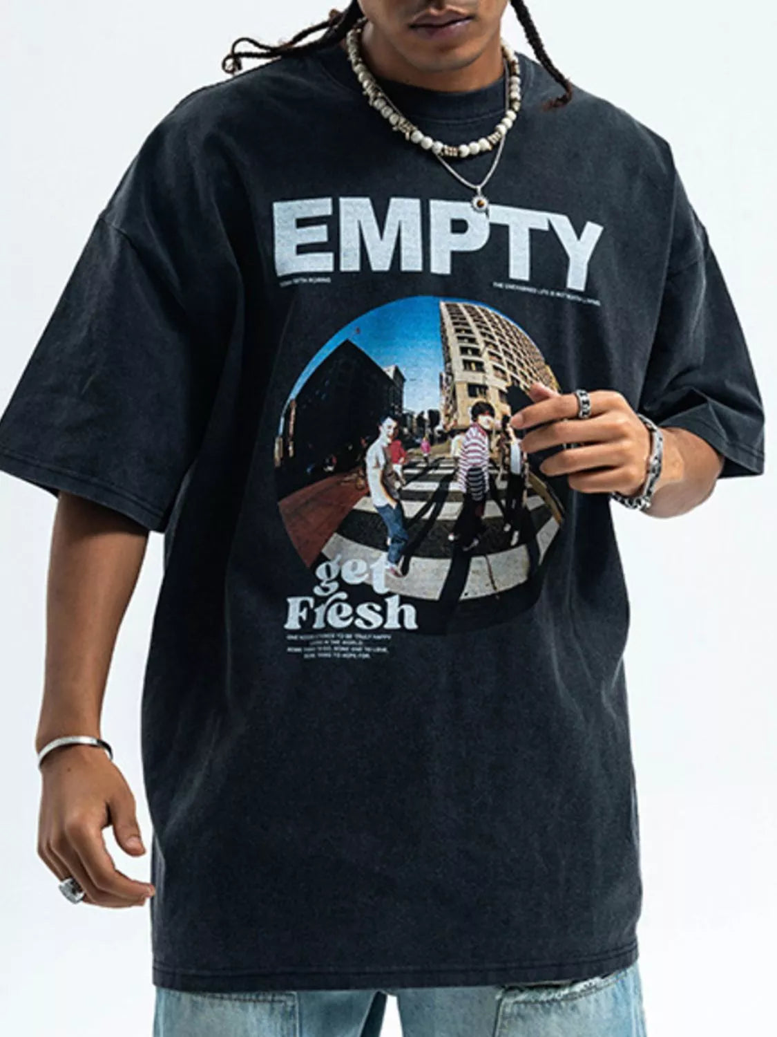 Person wearing a black t-shirt with 'EMPTY' and 'get Flesh' graphic design.