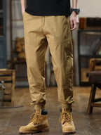 Person wearing tan pants and boots in an indoor setting