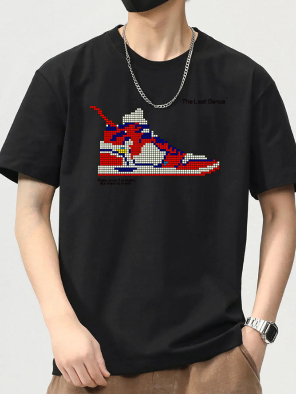 Black t-shirt with a colorful sneaker graphic on a plain background