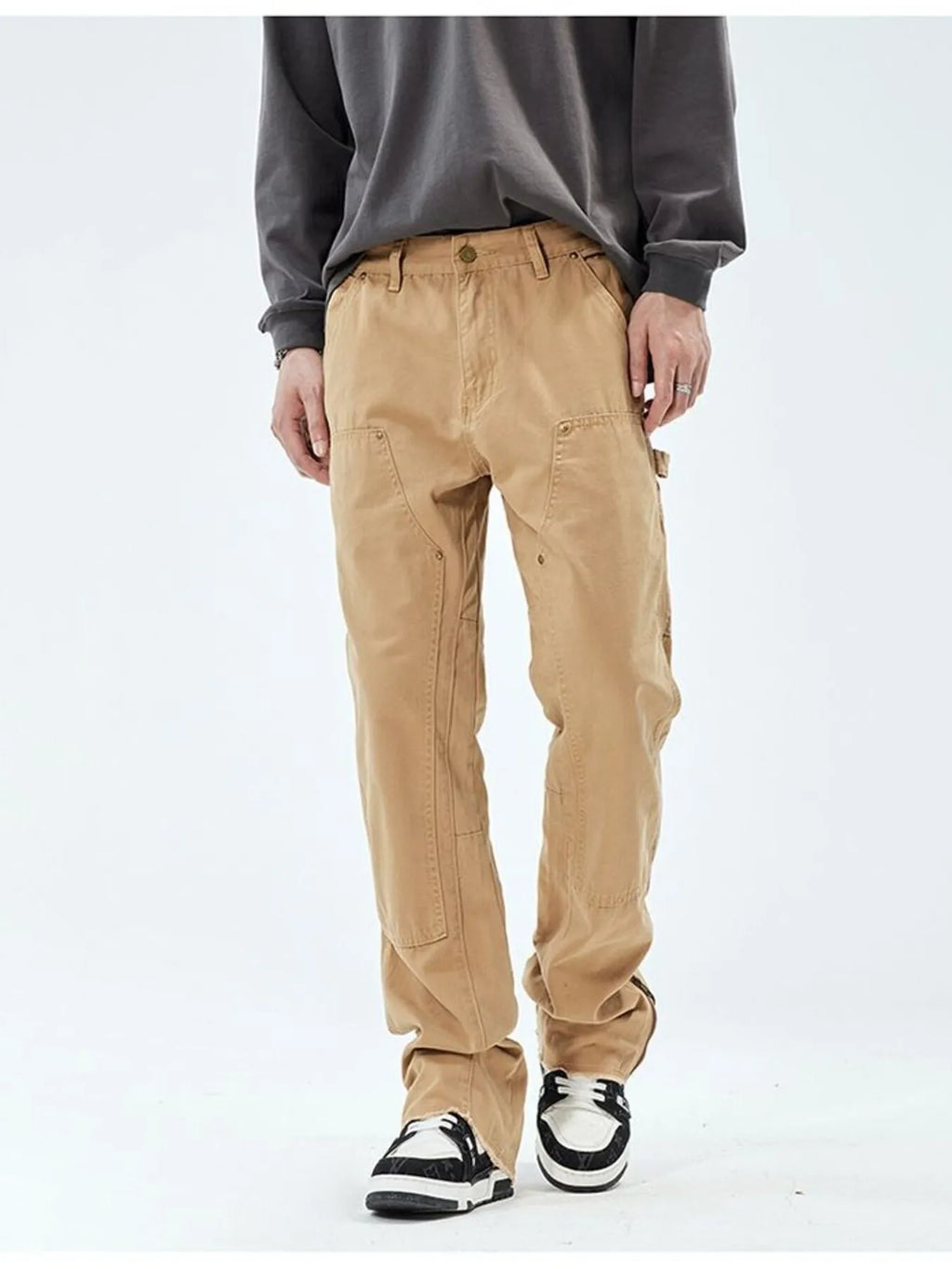 Person wearing beige cargo pants on a white background