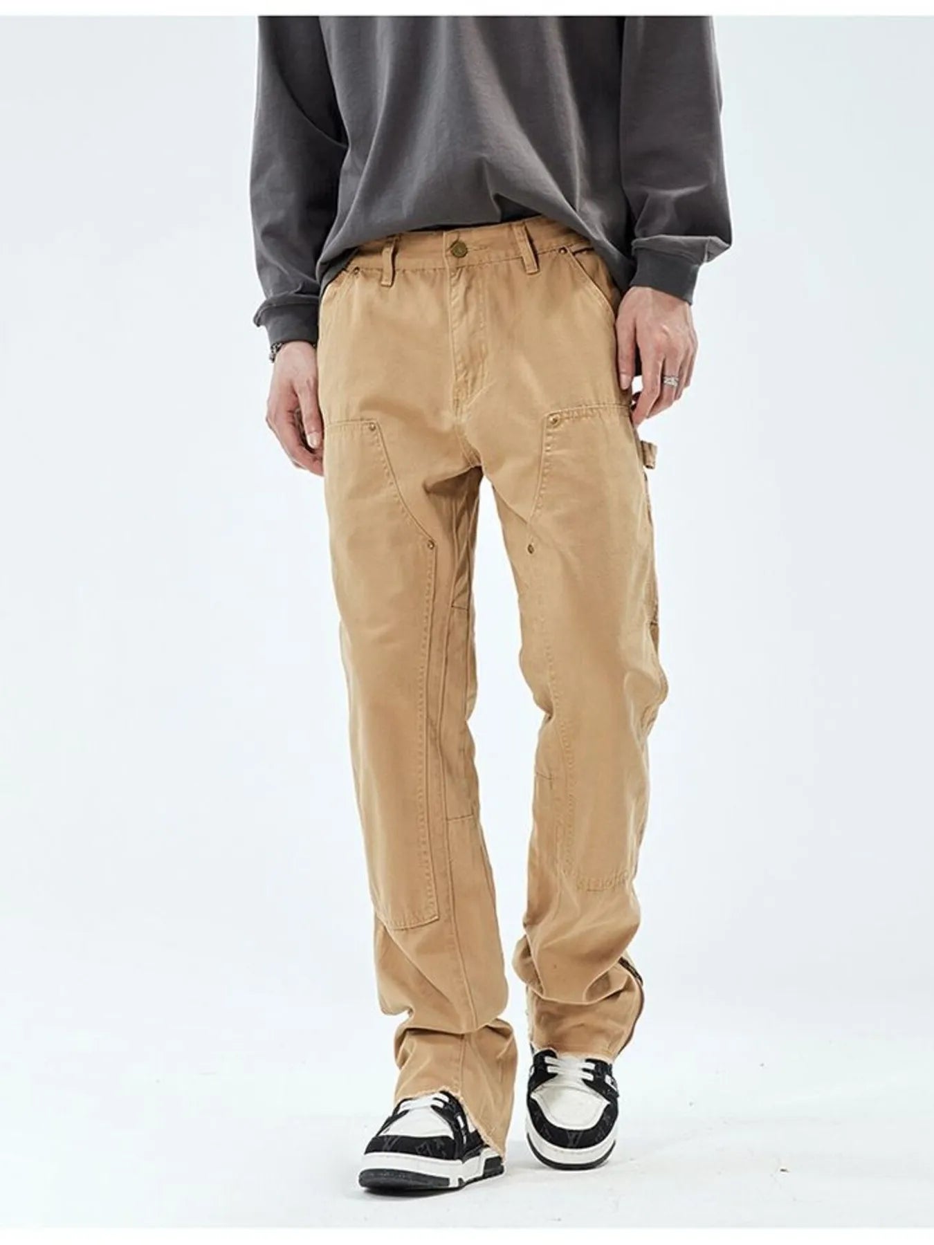 Person wearing beige cargo pants on a white background