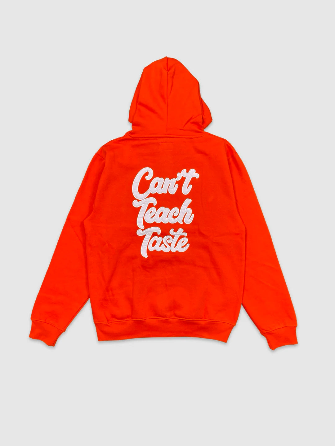Orange men’s hoodies with 'Can't Teach Taste' text on the back against a light gray background