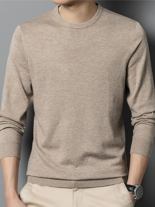 Beige men’s long sleeve shirt worn by a person against a gray background